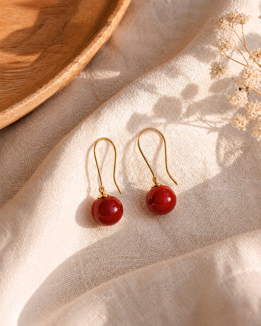 Cherry Drop Earrings with red bead drops and gold hooks.